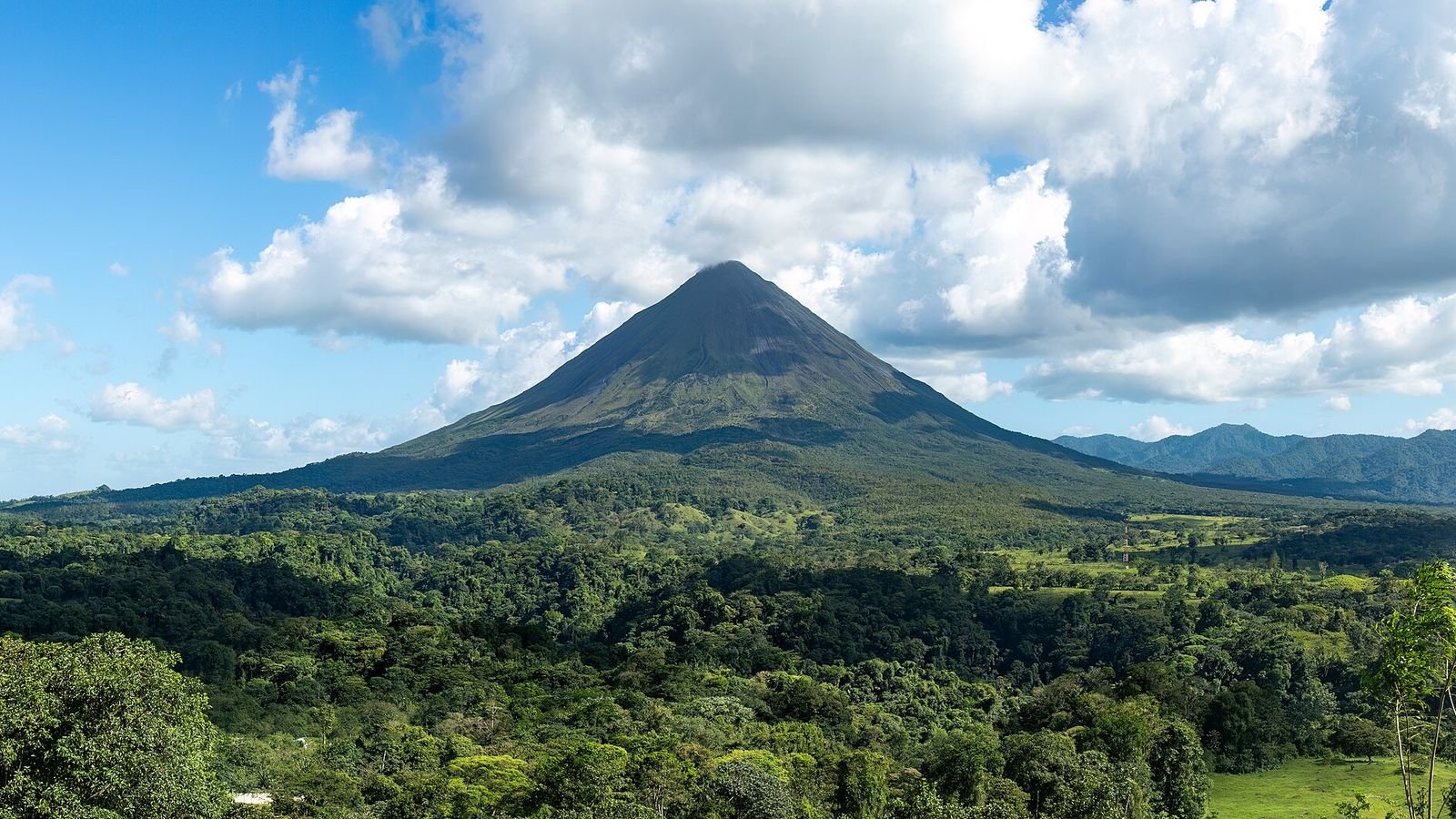 Arenal Volcano rising above rainforest, Costa Rica